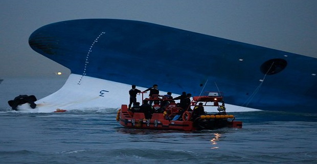 Maritime police search for missing passengers near capsized South Korean ferry "Sewol" at the sea off Jindo