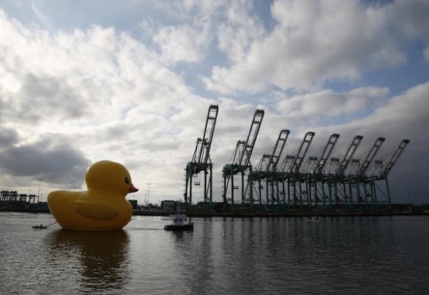 Giant inflatable rubber duck installation by Dutch artist Florentijn Hofman floats through the Port of Los Angeles as part of the Tall Ships Festival, in San Pedro