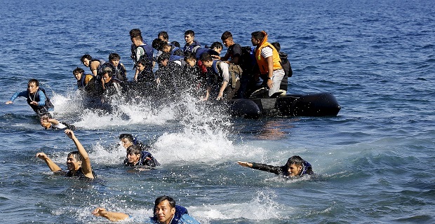 Afghan refugees struggle to swim ashore after their dinghy with a broken engine drifted out of control off the Greek island of Lesbos